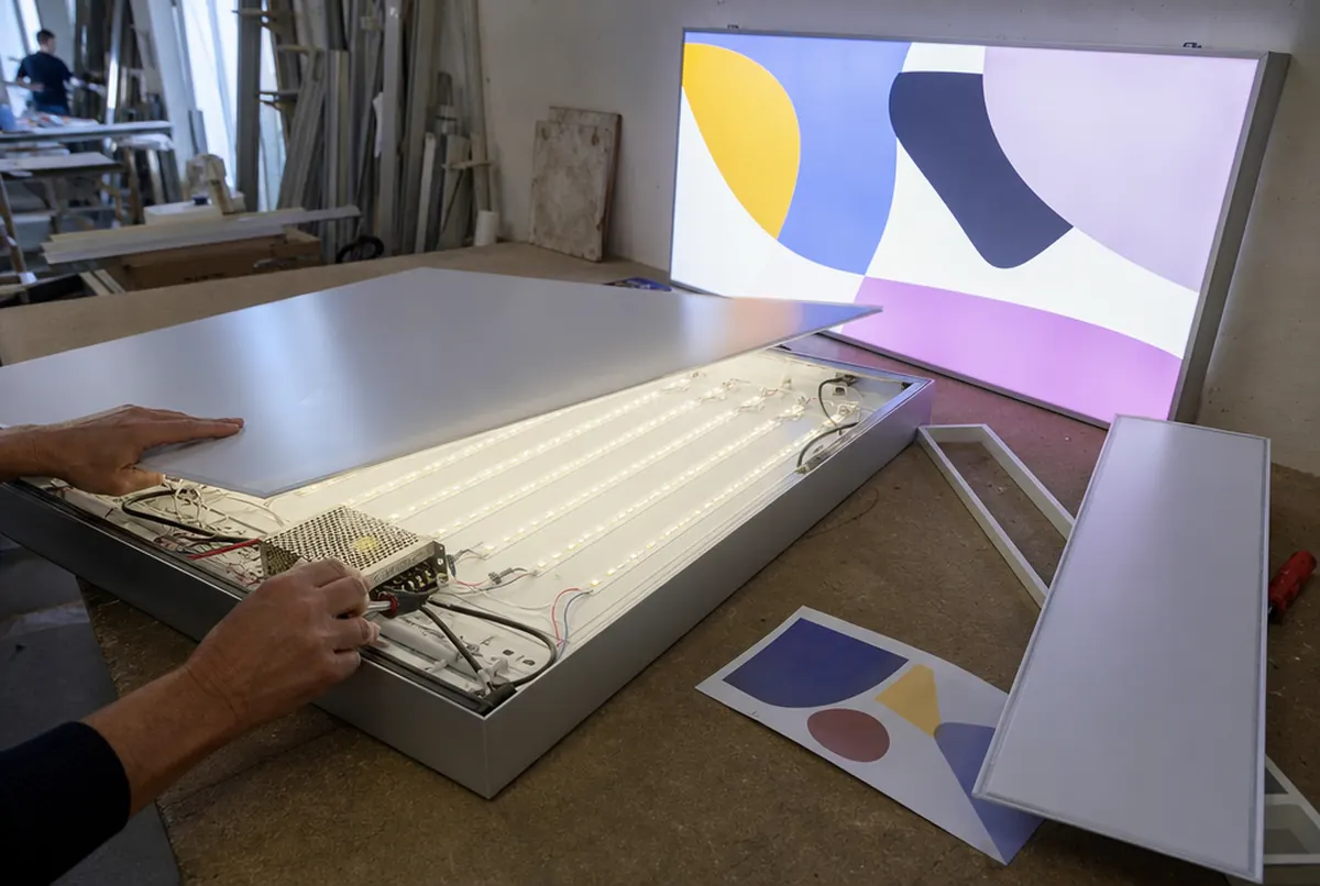 LED light box with the face removed being tested on a workshop bench