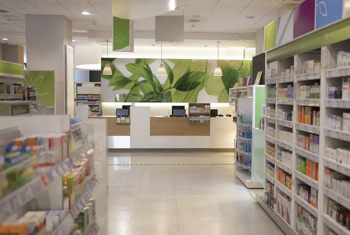 Pharmacy interior with graphics behind the counter and a privacy line on the floor