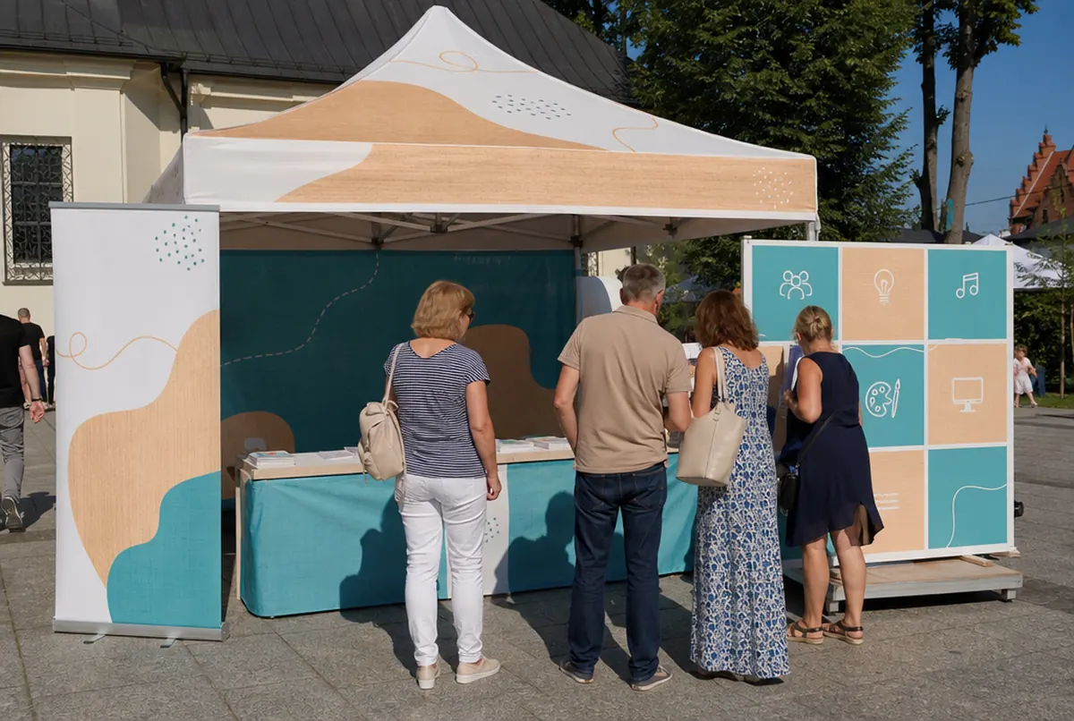 Community centre gazebo with a roll-up banner at a town festival
