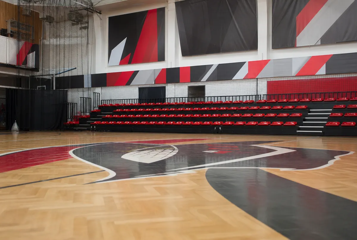 Sports hall with the club logo on the court and sponsor banners