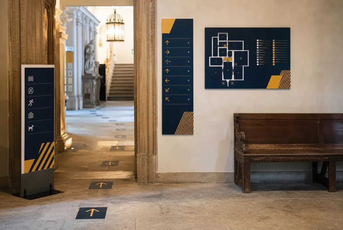 Directional signs, floor plan and visitor route in a museum