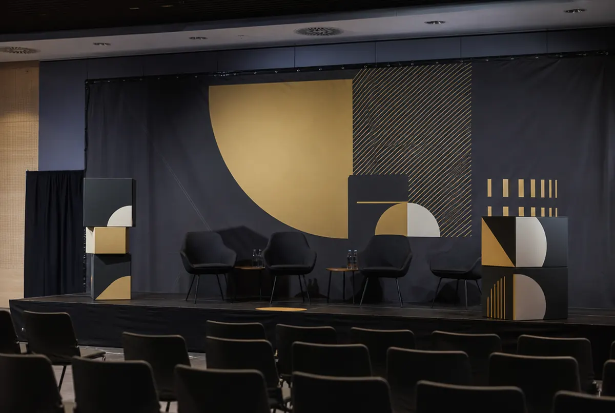 Event stage with a backdrop, speaker banners and 3D letters