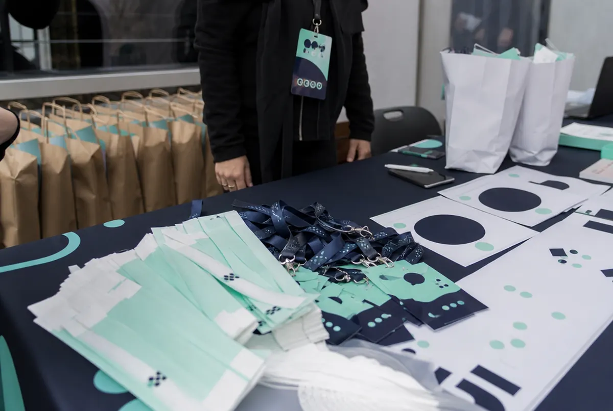 Badges, lanyards, wristbands and race packs on a registration table