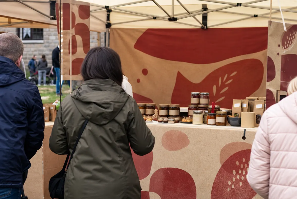Food producer’s tasting counter under a gazebo at a market