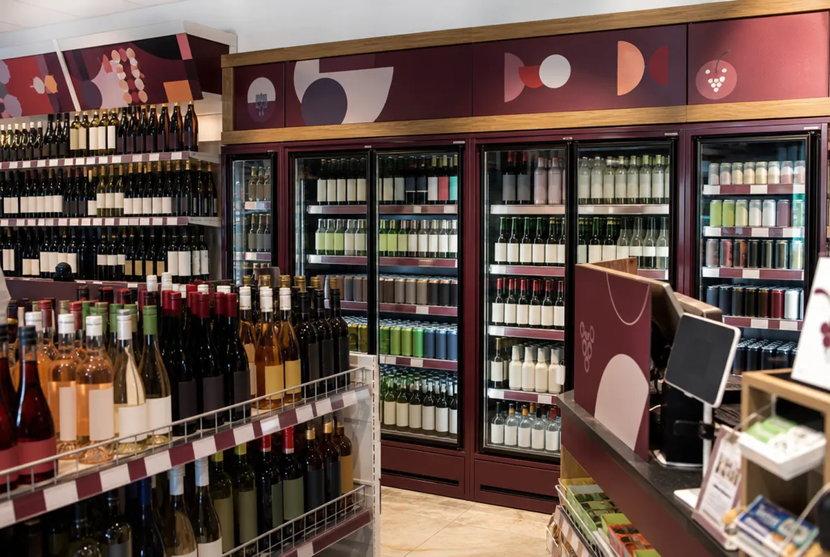 Wrapped chillers and aisle signs in an off-licence