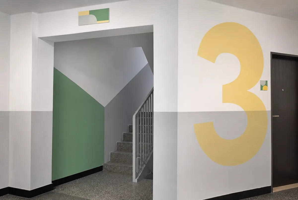 Block of flats stairwell with floor numbers and wall graphics