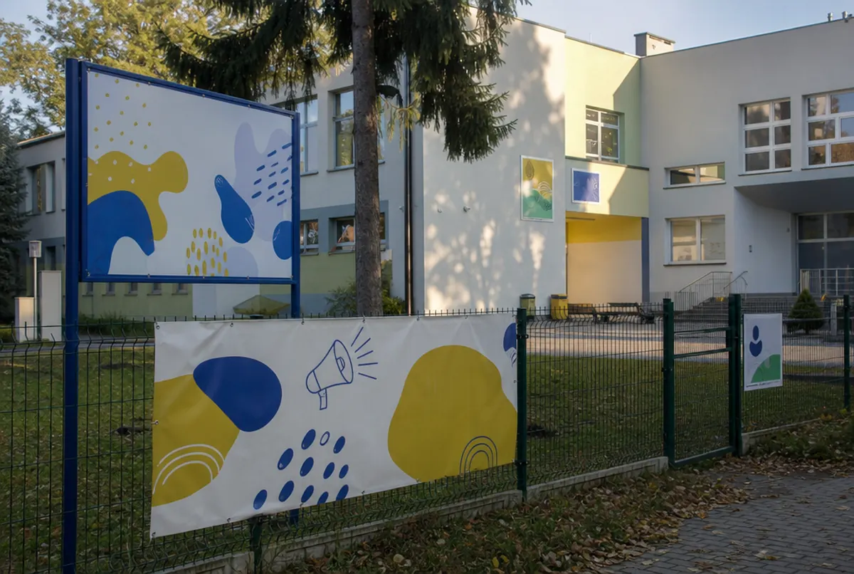 Enrolment banner on a school fence and a name board by the gate