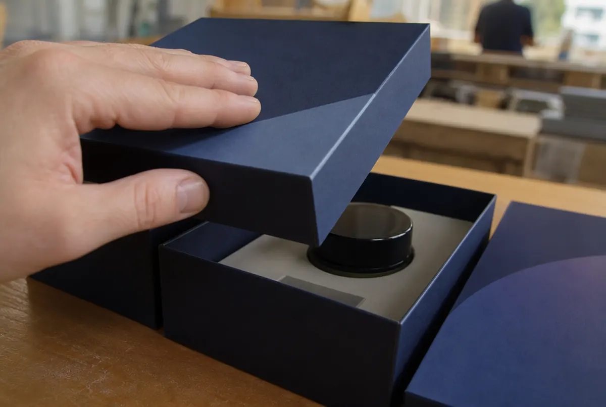 Close-up of a soft-touch laminated box with a cardboard insert holding the product