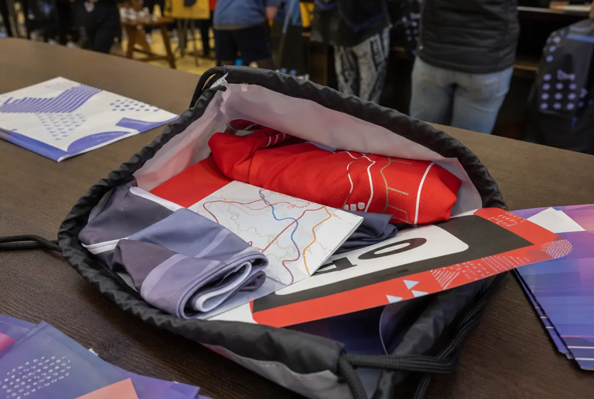 Contents of a race pack: T-shirt, bib, route map, neck tube and sponsor leaflets