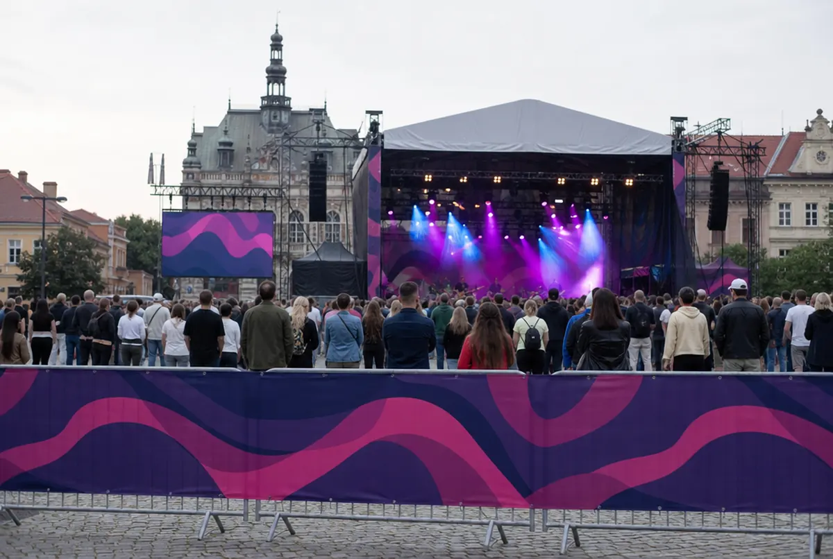 Stage barriers wrapped in printed mesh covers with a continuous graphic at a concert