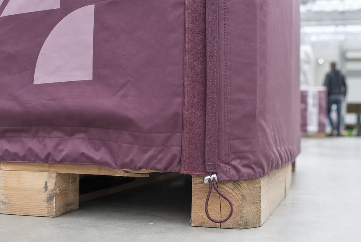 Close-up of a pallet cover's lower edge: hem, drawstring tunnel and hook-and-loop seam