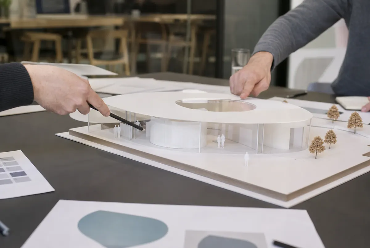 Exhibition pavilion model made of PVC, acrylic and 3D printed trees on a meeting table