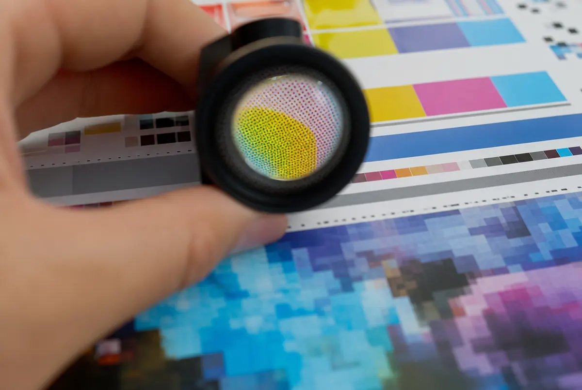 Close-up of a test print's colour control strip viewed through a loupe