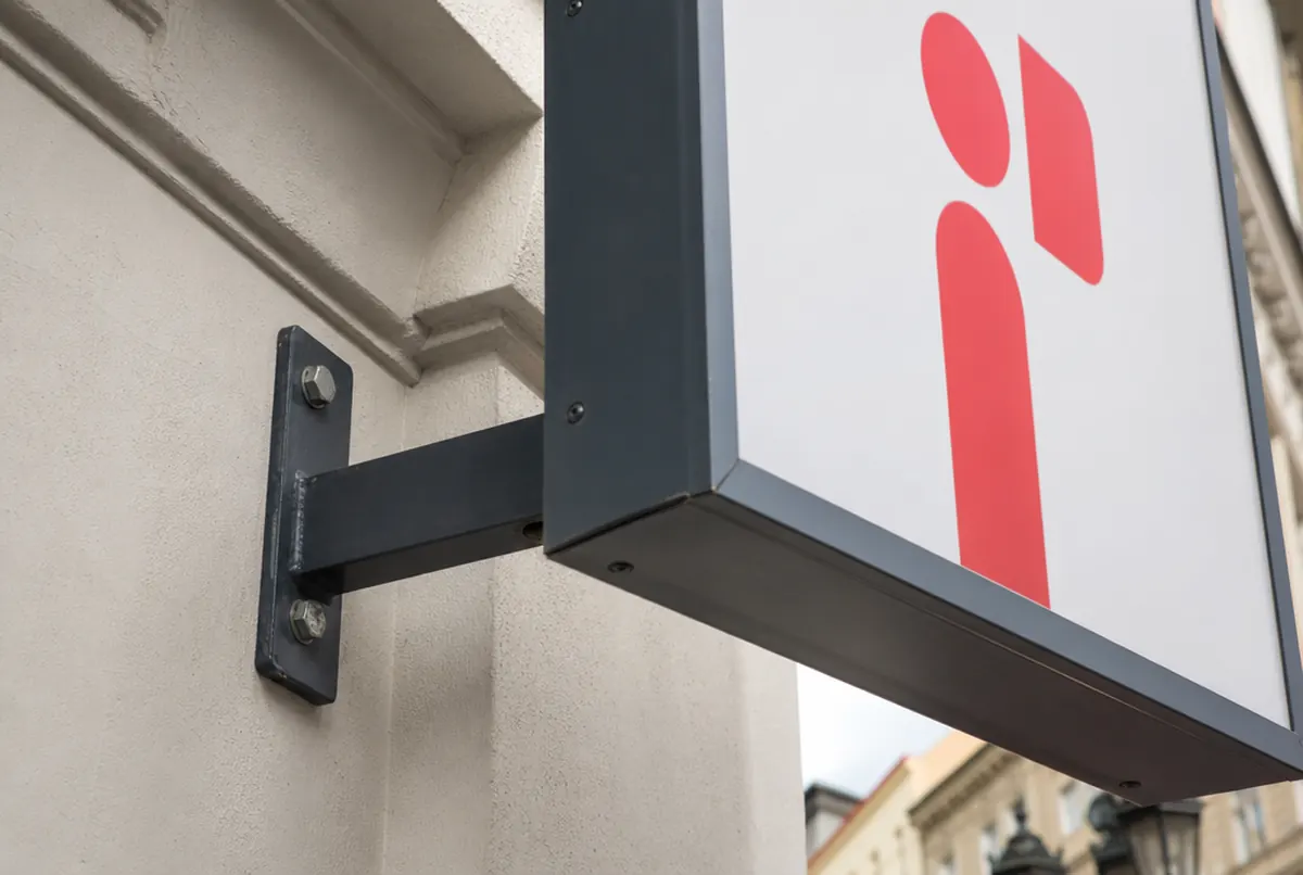 Projecting sign from below: steel bracket anchored in masonry and aluminium housing
