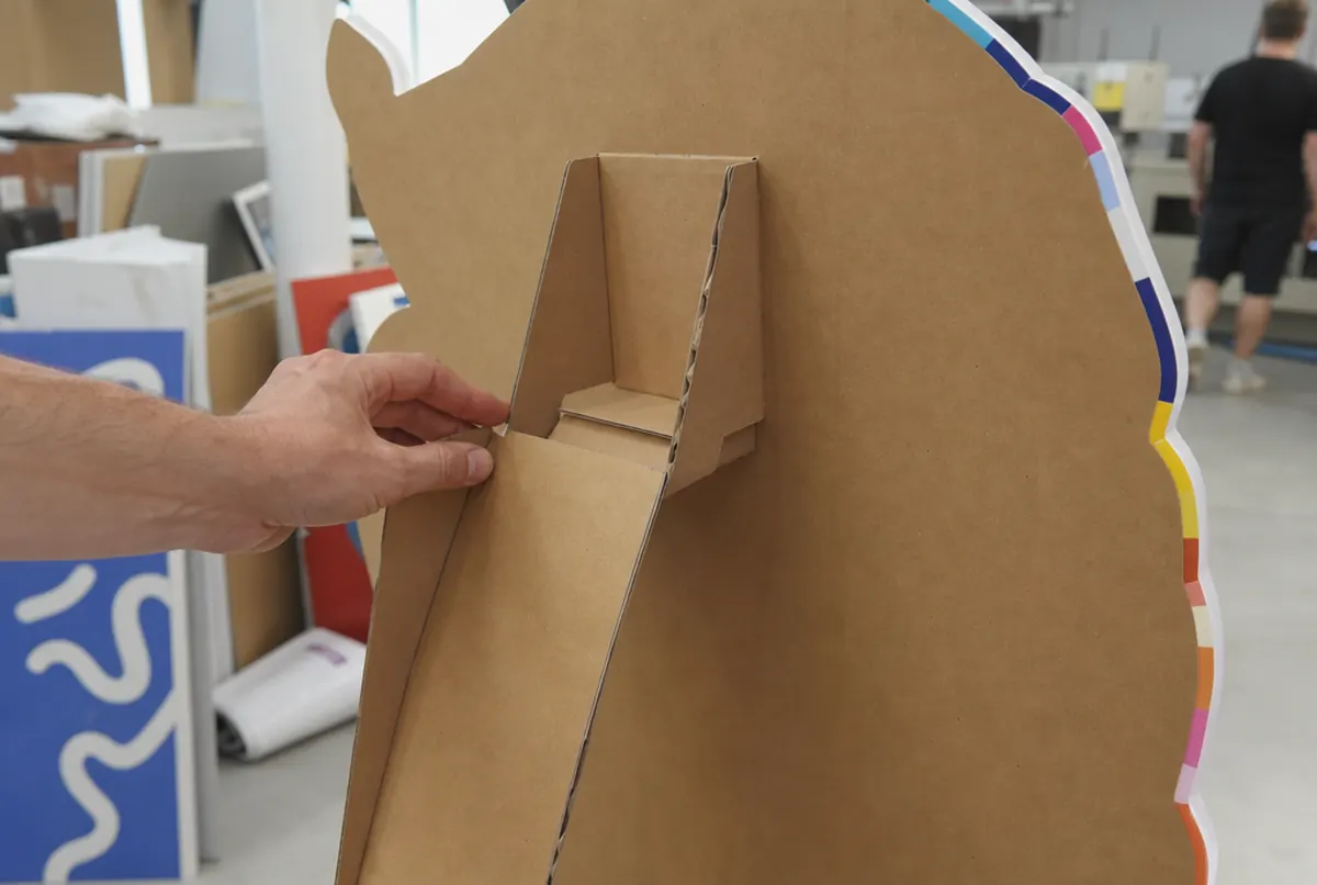 Back of a cardboard standee: folding easel support and clean contour-cut edge