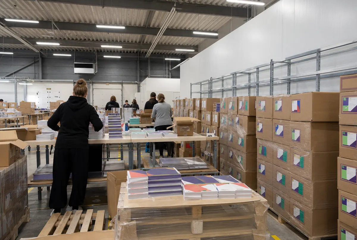 Assembling campaign kits by distribution list on long tables in the hall